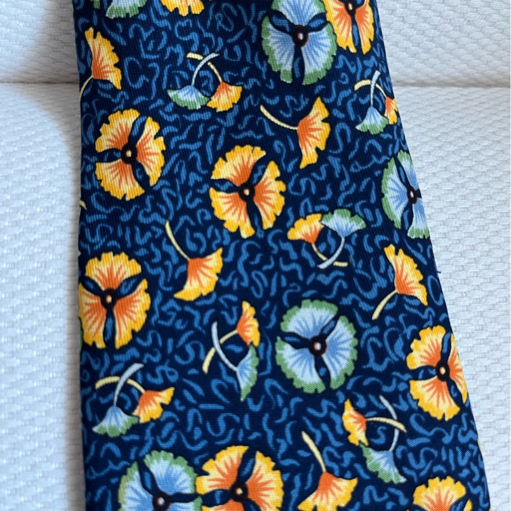 Preowned Hermes navy tie with yellow flowers.